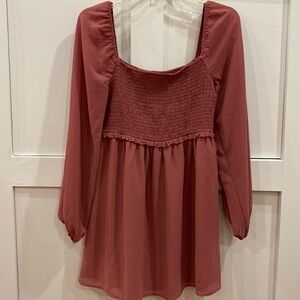 Flowy smocked mauve top. Sheer sleeves with elastic cuff.